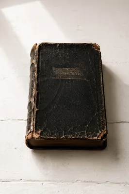 Old Worn Bible on White Tabletop