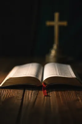 Open Bible on Rustic Wooden Table