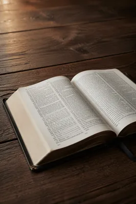 Open Bible on Dark Walnut Table