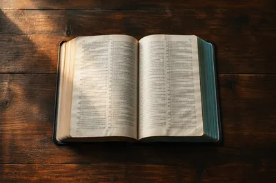 Open Bible on Dark Wooden Table