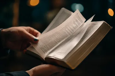 Open Bible Pages Turning in Gentle Breeze