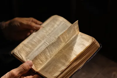 Open Bible Page Turning in Gentle Breeze