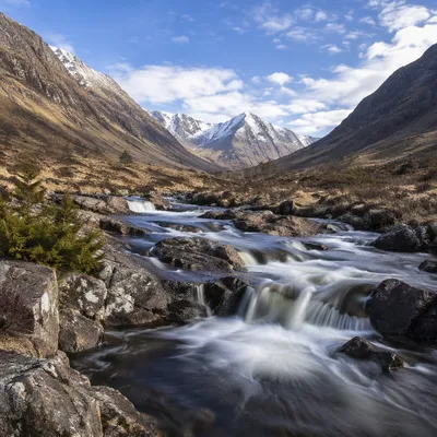 Peaceful River Valley with Evergreen Slopes