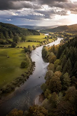 Peaceful River Valley Under Golden Clouds