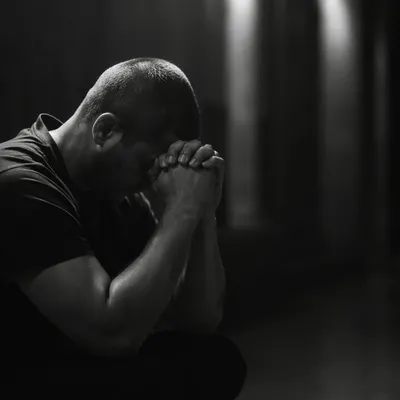 Kneeling Prayer in Quiet Monochrome