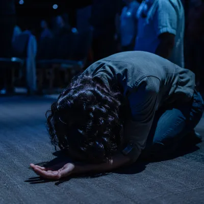 Kneeling Prayer in Blue Chapel Light