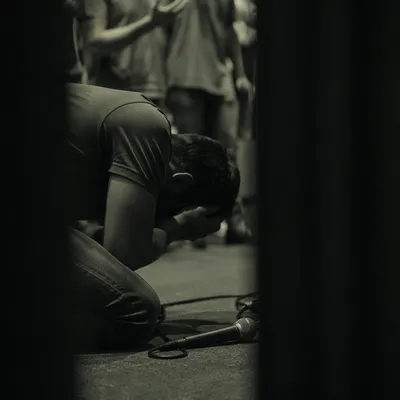 Person Kneeling in Prayer Indoors