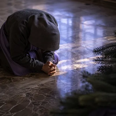 Humble Prayer on Reflective Stone Floor