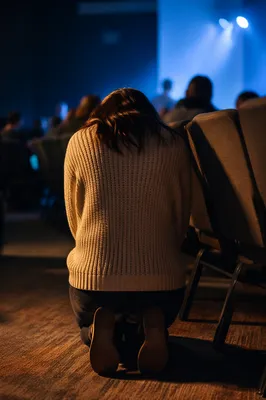 Quiet Prayer in Dim Auditorium