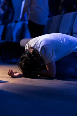 Person Kneeling in Quiet Prayer