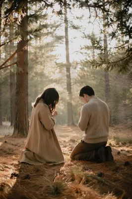 Two People Kneeling in Evergreen Prayer