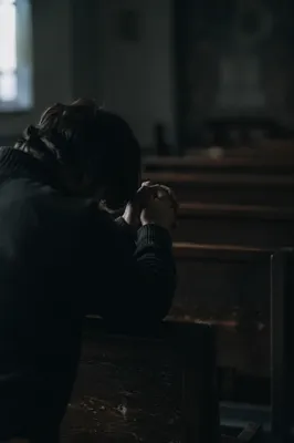 Quiet Prayer Beside a Wooden Chapel Pew