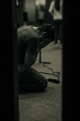Person Kneeling in Prayer Indoors