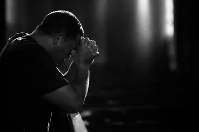 Kneeling Prayer in Quiet Monochrome Light