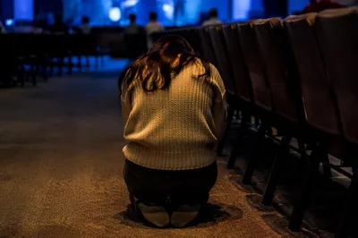 Quiet Prayer Beside Empty Auditorium Seats
