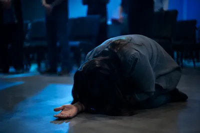 Kneeling Prayer in Blue Sanctuary Light