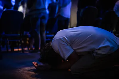 Person Kneeling in Quiet Prayer