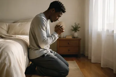 Young Man Kneeling in Bedroom Prayer