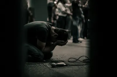 Kneeling Person in Dim Prayer Scene