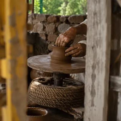 Potter Hands Shaping Clay in Rustic Studio