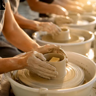 Potter Hands Shaping Clay in Warm Light
