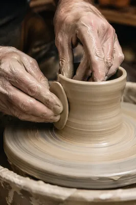 Potter Hands Shaping Clay Vessel
