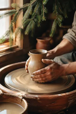 Potter Hands Shaping Clay with Evergreen Hope
