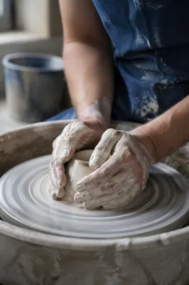 Potter Hands Shaping Clay at Wheel
