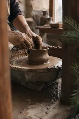 Potter Hands Shaping Clay in Rustic Workshop