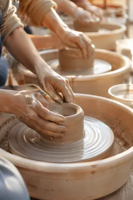 Potter Hands Shaping Clay in Sunlit Studio