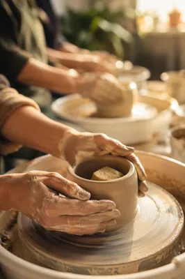 Potter Hands Shaping Clay in Warm Studio