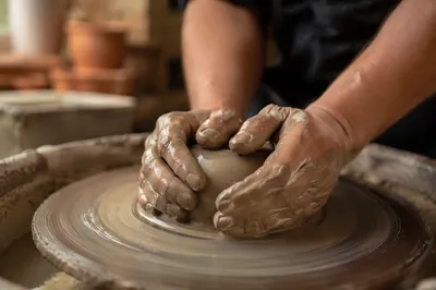 Potter Hands Shaping Clay on Wheel