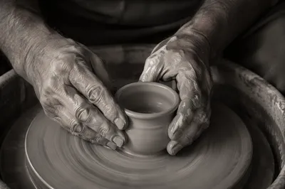 Potter Hands Shaping Clay Vessel