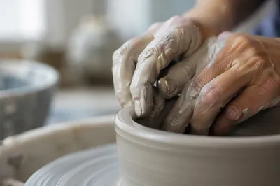 Potter Hands Shaping Clay Vessel