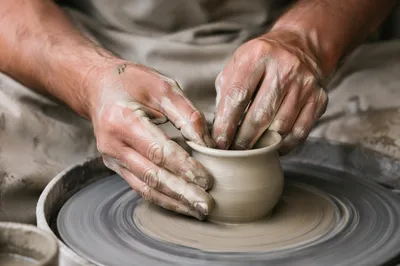 Potter Hands Shaping Wet Clay Vessel