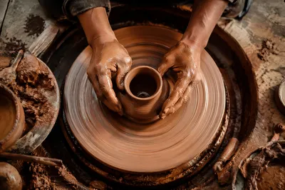 Potter Hands Shaping Clay on Wheel