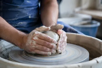 Potter Hands Shaping Clay in Studio