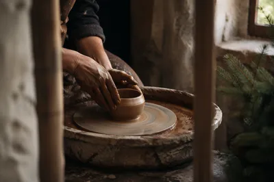 Potter Hands Shaping Clay in Workshop