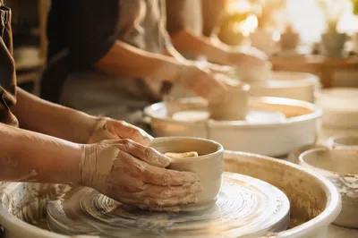 Hands Shaping Clay in Warm Workshop Light