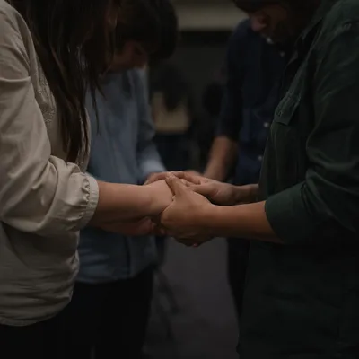 Clasped Hands in Reverent Prayer Gathering