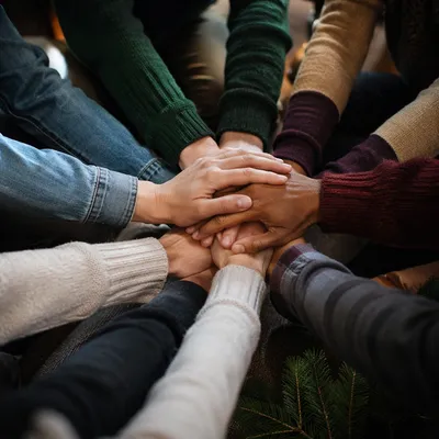 Prayer Group Hands Joined in Evergreen Fellowship