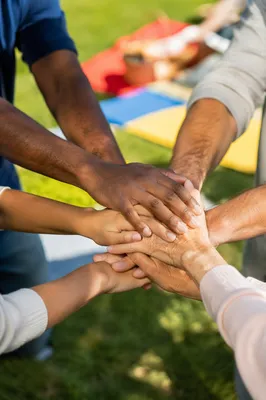 Intergenerational Prayer Hands in Sunlit Fellowship