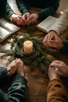 Prayer Group Hands Around Evergreen Candle