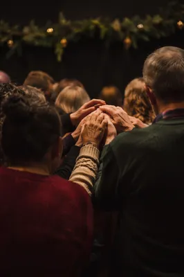 Diverse Prayer Group Joining Hands in Sanctuary