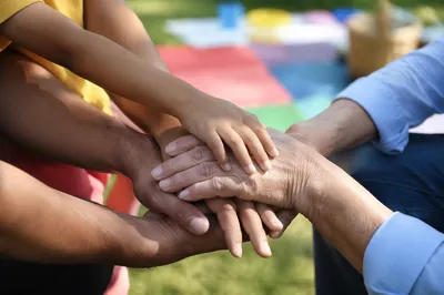 Intergenerational Prayer Hands on Grass