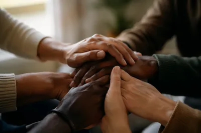 Prayer Circle Hands in Soft Evergreen Light