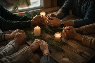 Prayer Group Hands Around Evergreen Candle Table