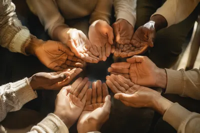 Prayer Circle Hands in Warm Light