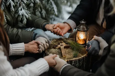 Winter Prayer Hands Around Wooden Cross
