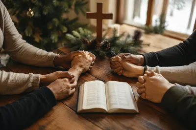 Prayer Group Hands Around Evergreen Chapel Table